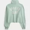 Easy New York Graphic Cutoff-Sweatshirt mit halbem Reißverschluss Easy New York Graphic Cutoff-Sweatshirt mit halbem Reißverschluss