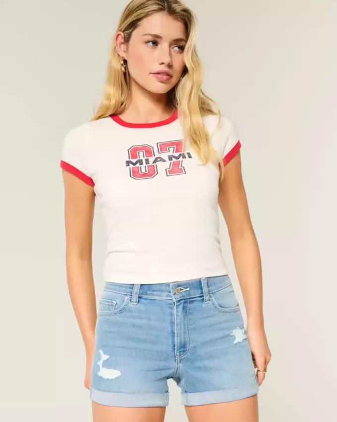High-Rise Ripped Denim Shortie Shorts in mittlerer heller Waschung High-Rise Ripped Denim Shortie Shorts in mittlerer heller Waschung
