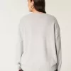 Hollister – Bequemer Pullover mit Rundhalsausschnitt und Cloud Puppy-Grafik Hollister – Bequemer Pullover mit Rundhalsausschnitt und Cloud Puppy-Grafik