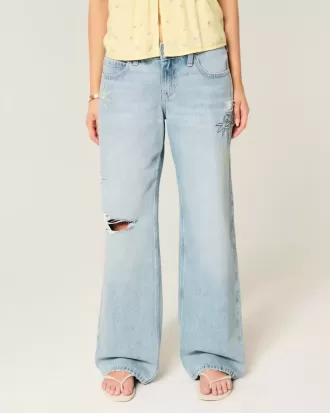 Niedrig geschnittene Baggy-Jeans mit Rissen und heller Waschung und Grafik