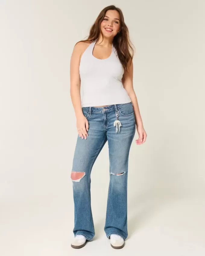 Niedrig sitzende Bootcut-Jeans mit Rissen in mittlerer Waschung
