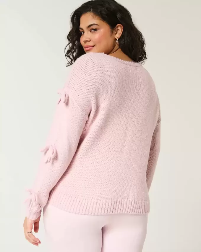 Schulterfreier Pullover mit Schleifenapplikation Schulterfreier Pullover mit Schleifenapplikation