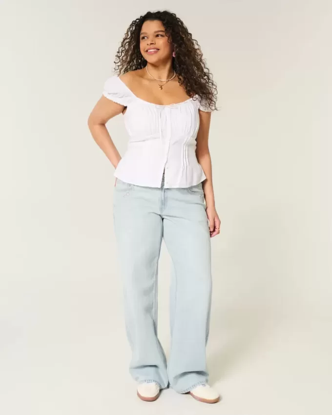 Tief sitzende Baggy-Jeans mit heller Waschung und Sternstickerei