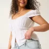 Tief sitzende Baggy-Jeans mit heller Waschung und Sternstickerei