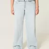 Tief sitzende Baggy-Jeans mit heller Waschung und Sternstickerei