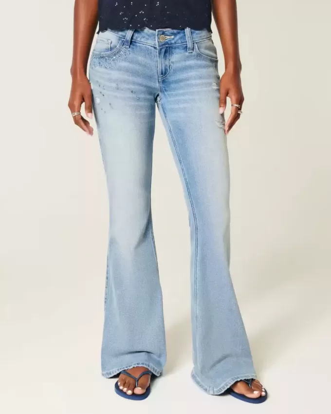 Ultra Low-Rise Distressed Light Wash Flare Jeans mit Pailletten