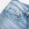 Ultra Low-Rise Distressed Light Wash Flare Jeans mit Pailletten