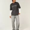 Verwaschene schwarze Baggy-Jeans mit Grafik und Verzierung Verwaschene schwarze Baggy-Jeans mit Grafik und Verzierung
