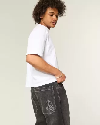 Verwaschene schwarze Skater-Baggy-Jeans mit Schlangenstickerei