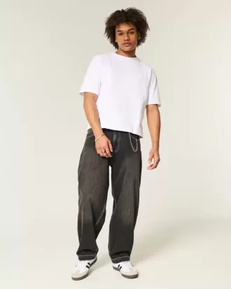 Verwaschene schwarze Skater-Baggy-Jeans mit Schlangenstickerei