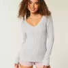 Zopfmuster-Pullover mit V-Ausschnitt und Symbol