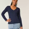 Zopfmuster-Pullover mit V-Ausschnitt und Symbol