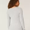 Zopfmuster-Pullover mit V-Ausschnitt und Symbol