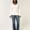 Zopfmuster-Pullover mit V-Ausschnitt und Symbol